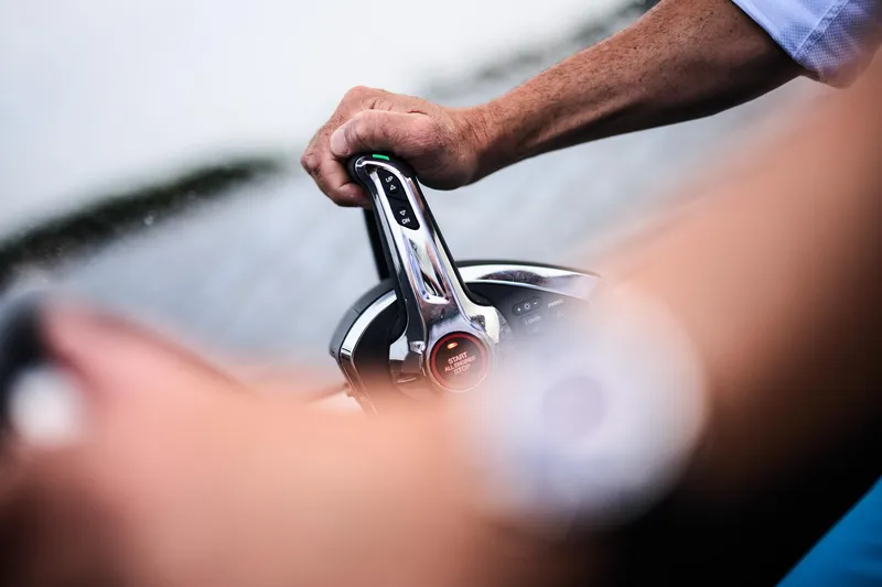 Slide: The Image of A person steering a 2025 Skamander Sorrento boat on water. - 28
