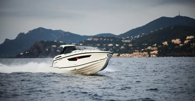 Slide: The Image of 2025 Skamander Sorrento boat cruising on water with scenic mountain backdrop. - 37