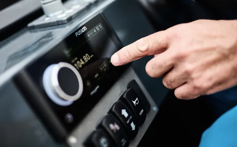 Slide: The Image of Person adjusting Skamander Sorrento 2025 dashboard controls, focusing on digital display. - 42