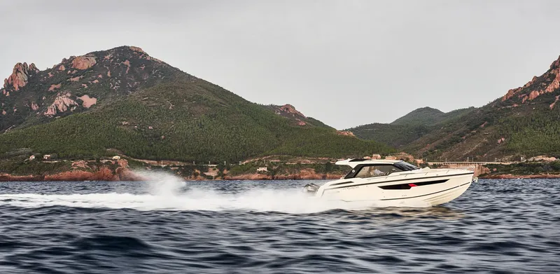 Slide: The Image of 2025 Skamander Sorrento boat cruising on water with scenic mountain backdrop. - 47