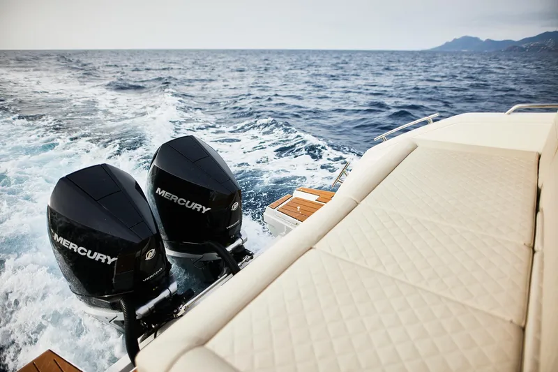 Slide: The Image of 2025 Skamander Sorrento boat with dual Mercury engines cruising on open water. - 6