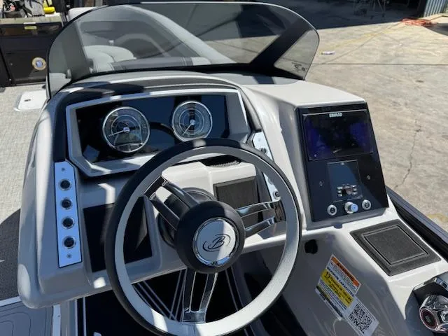 Slide: The Image of 2025 Barletta CORSA 25MA boat dashboard with steering wheel and control panel. - 23