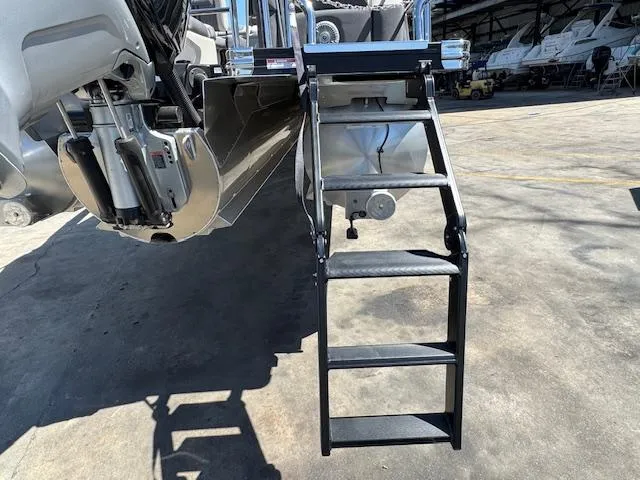 Slide: The Image of 2025 Barletta CORSA 25MA boat ladder and engine detail in a marina setting. - 26