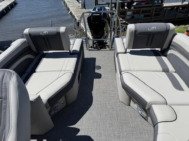 Slide: The Image of 2025 Barletta CORSA 25MA pontoon boat with luxurious seating, docked by the water. - 7