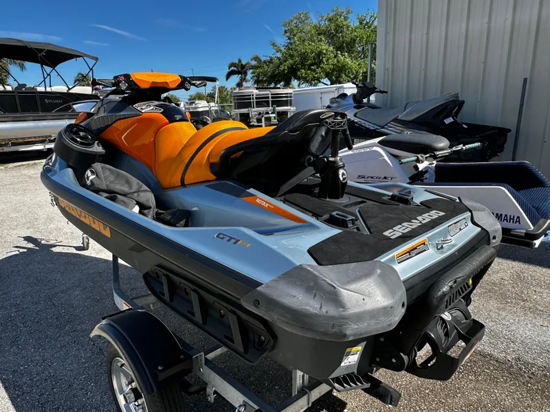 Slide: The Image of 2020 Sea-Doo GTI SE 130 jet ski on trailer, orange and gray design. - 11
