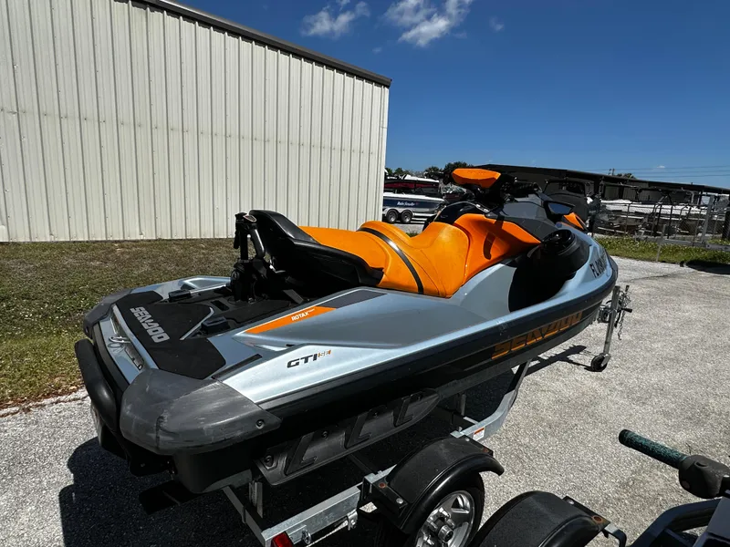 Slide: The Image of 2020 Sea-Doo GTI SE 130 jet ski on trailer, parked outdoors. - 2
