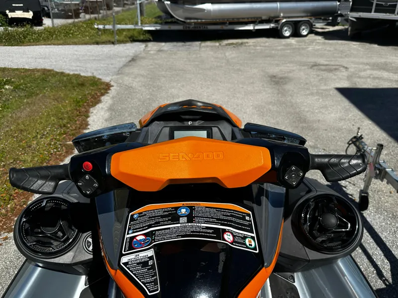 Slide: The Image of 2020 Sea-Doo GTI SE 130 handlebars and dashboard, featuring orange accents and control buttons. - 6