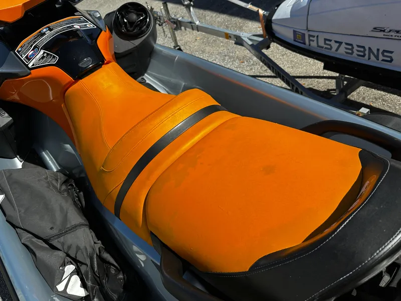 Slide: The Image of 2020 Sea-Doo GTI SE 130 with vibrant orange seat, parked on a trailer. - 7