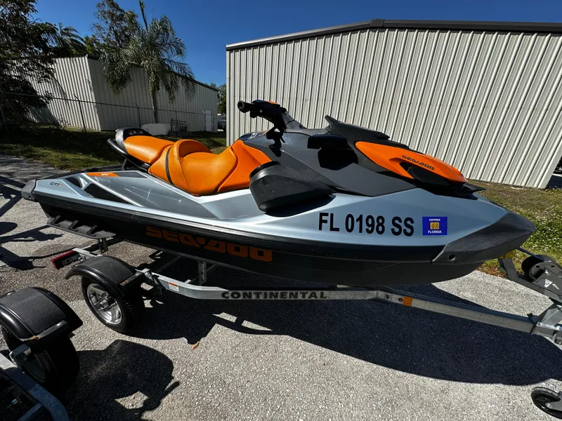 Slide: The Image of 2020 Sea-Doo GTI SE 130 jet ski on trailer, orange and black design. - 8