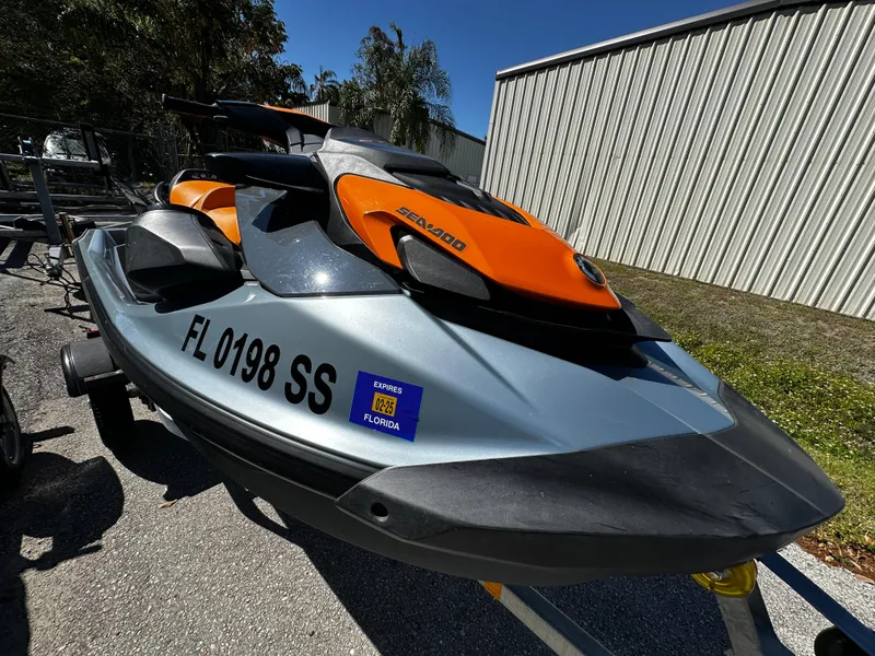 Slide: The Image of 2020 Sea-Doo GTI SE 130 jet ski, orange and gray, parked outdoors. - 9