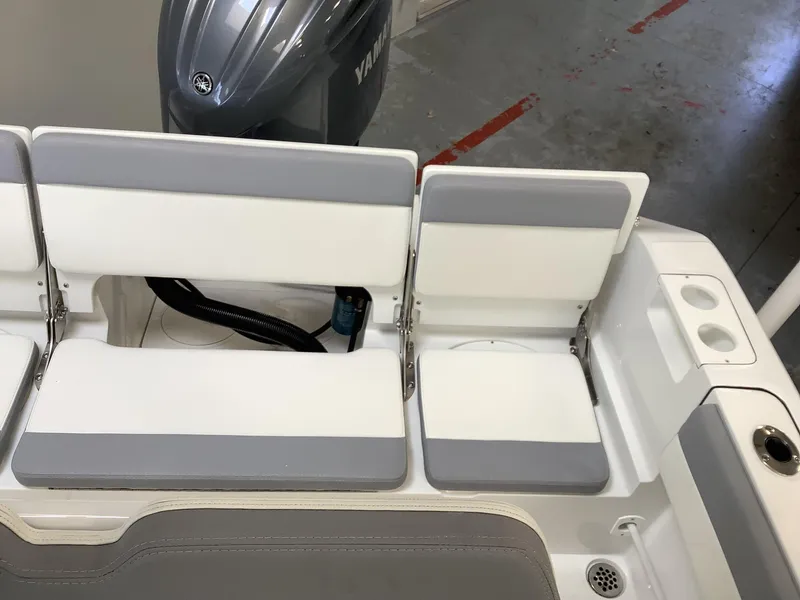 Slide: The Image of 2025 Release 210RX Center Console boat seating with Yamaha engine in a garage setting. - 10