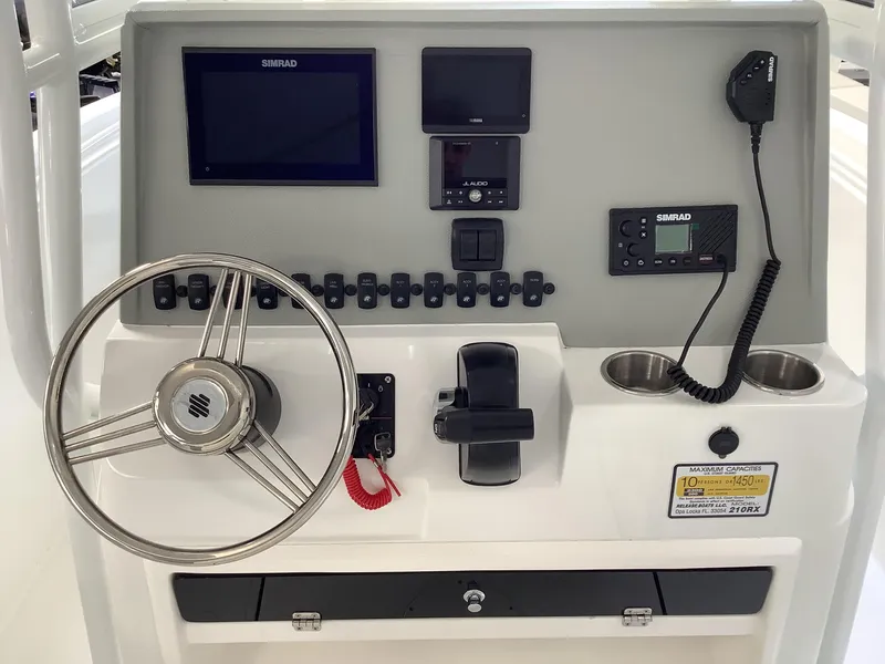 Slide: The Image of 2025 Release 210RX Center Console dashboard with steering wheel, controls, and electronic displays. - 13