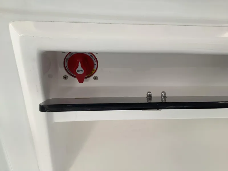 Slide: The Image of 2025 Release 210RX Center Console, battery switch detail in white compartment. - 15