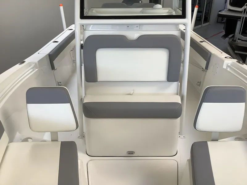 Slide: The Image of 2025 Release 210RX Center Console boat interior with gray and white seating. - 19