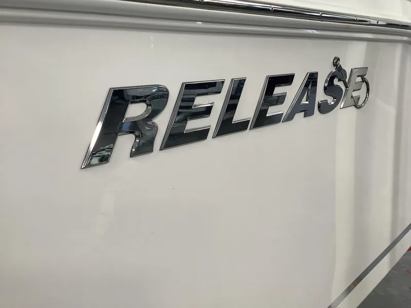 Slide: The Image of 2025 Release 210RX Center Console boat logo on white surface. - 2