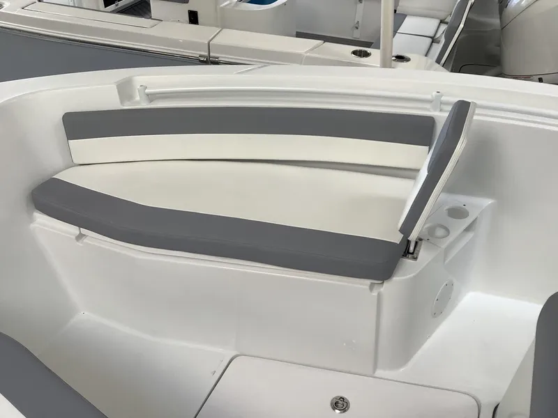 Slide: The Image of 2025 Release 210RX Center Console boat seating with gray and white cushions. - 21