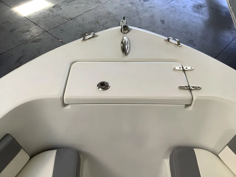 Slide: The Image of 2025 Release 210RX Center Console boat interior with storage compartment and seating. - 23