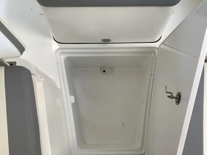 Slide: The Image of 2025 Release 210RX Center Console storage compartment, open lid, white interior, gray seating. - 26