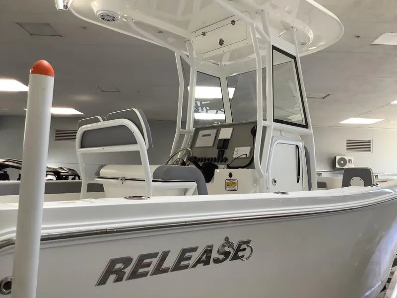 Slide: The Image of 2025 Release 210RX Center Console boat in showroom, featuring sleek design and modern amenities. - 3