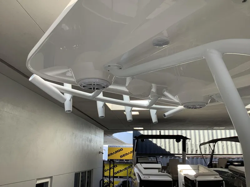 Slide: The Image of 2025 Release 210RX Center Console boat with rod holders and speakers under canopy. - 31