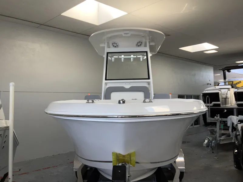 Slide: The Image of 2025 Release 210RX Center Console boat in showroom, front view. - 4