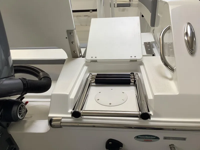 Slide: The Image of 2025 Release 210RX Center Console boat with stainless steel ladder and sleek design. - 8