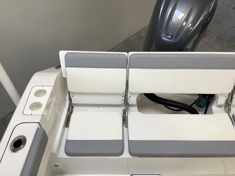 Slide: The Image of 2025 Release 210RX Center Console boat seating with gray and white cushions. - 9