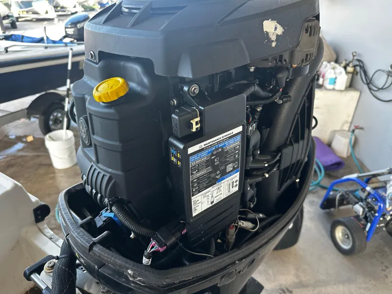 Slide: The Image of 2021 Bayliner VR6 Bowrider OB outboard engine close-up in a garage setting. - 15