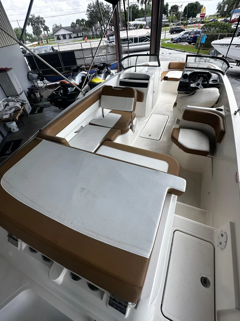 Slide: The Image of 2021 Bayliner VR6 Bowrider OB with spacious seating and modern design in a marina setting. - 19