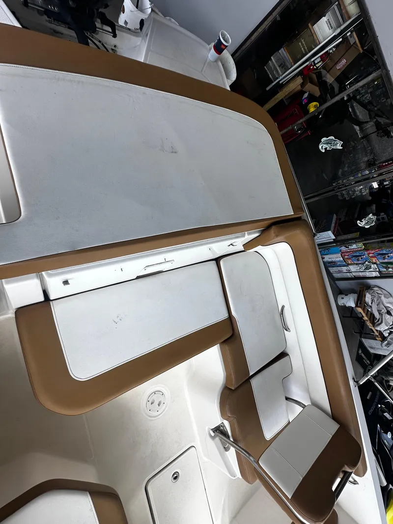 Slide: The Image of 2021 Bayliner VR6 Bowrider OB interior with tan and white seating. - 20