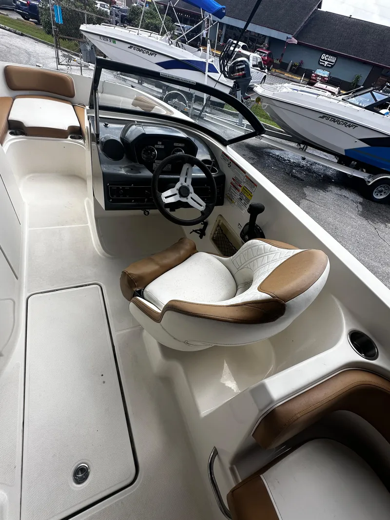 Slide: The Image of 2021 Bayliner VR6 Bowrider OB interior with steering wheel and seating. - 23