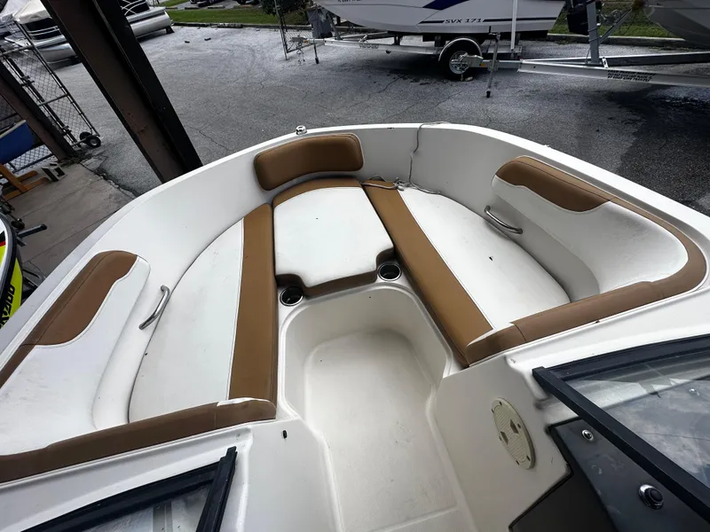 Slide: The Image of 2021 Bayliner VR6 Bowrider OB interior with tan and white seating. - 24
