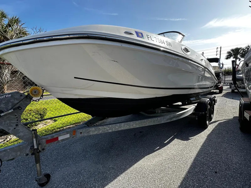 Slide: The Image of 2021 Bayliner VR6 Bowrider OB on trailer, parked outdoors under clear sky. - 3