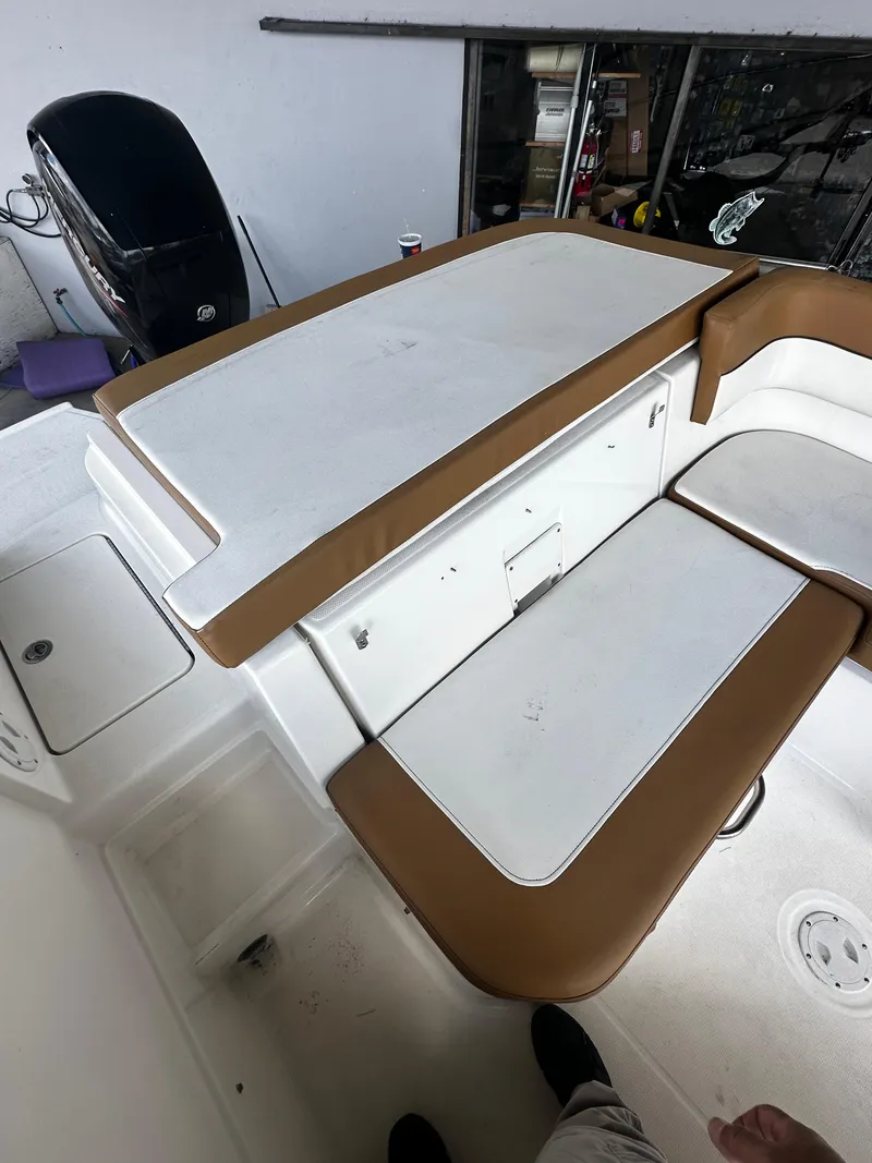 Slide: The Image of 2021 Bayliner VR6 Bowrider OB interior with brown and white seating. - 31