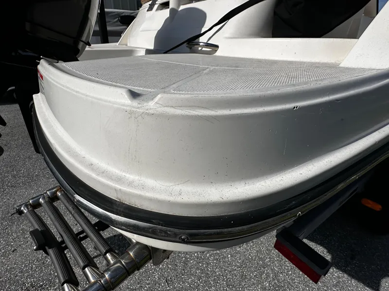 Slide: The Image of 2021 Bayliner VR6 Bowrider OB rear view with swim platform and ladder. - 6