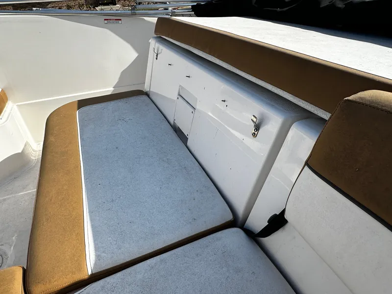 Slide: The Image of 2021 Bayliner VR6 Bowrider OB interior seating with white and brown upholstery. - 9