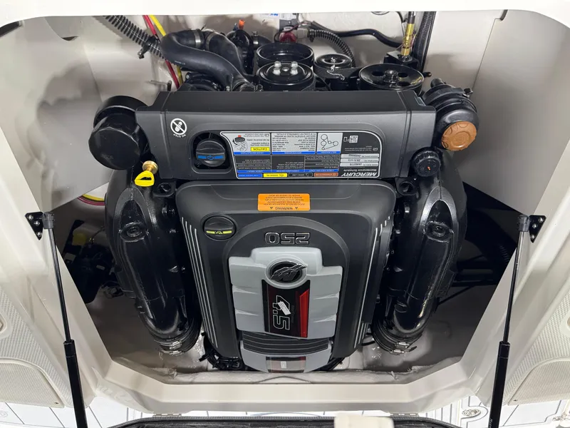 Slide: The Image of 2025 Chaparral 21 SSi boat interior storage compartment with blue lining. - 12