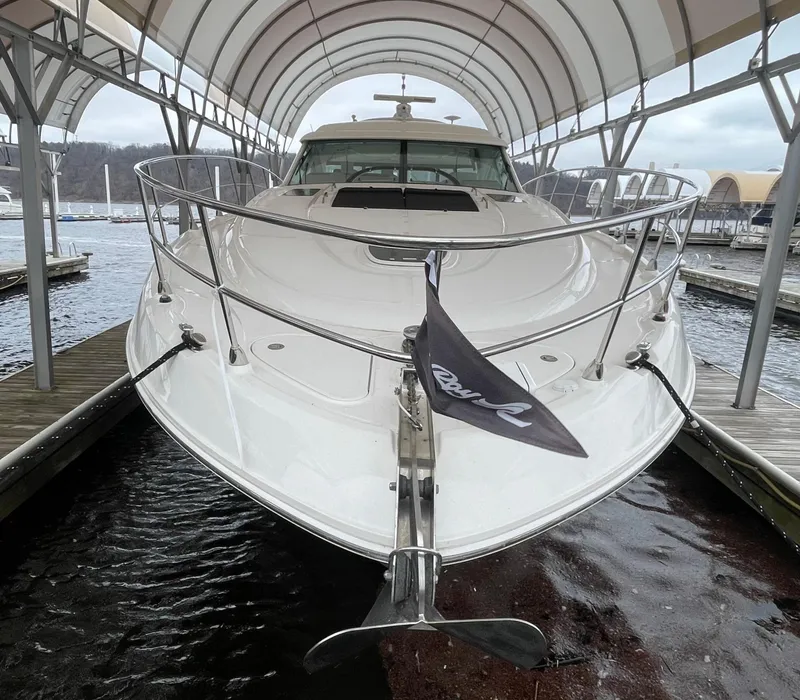 Slide: The Image of 2008 Sea Ray 550 Sundancer yacht docked under a canopy at a marina. - 10