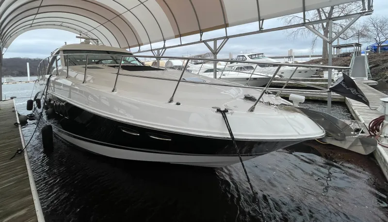 Slide: The Image of 2008 Sea Ray 550 Sundancer yacht docked under a canopy. - 13