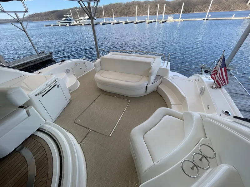 Slide: The Image of 2008 Sea Ray 550 Sundancer yacht with spacious seating, docked by a serene lake. - 19