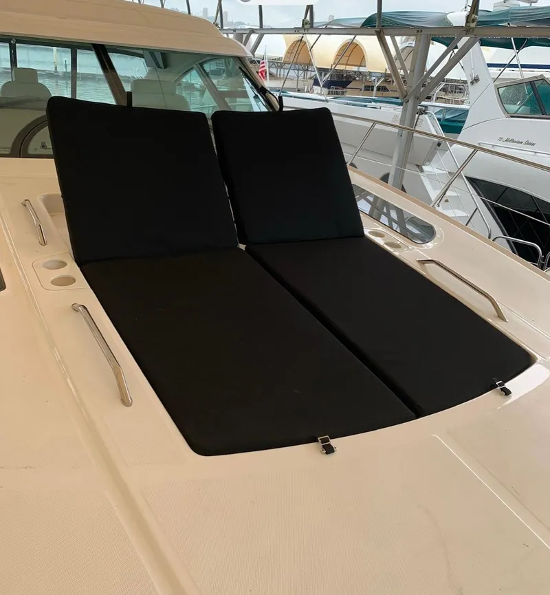 Slide: The Image of 2008 Sea Ray 550 Sundancer yacht with black sun loungers on deck. - 2