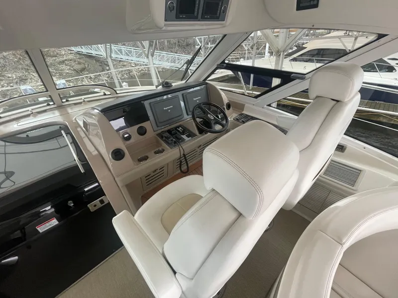 Slide: The Image of 2008 Sea Ray 550 Sundancer helm with modern controls and luxurious seating. - 27