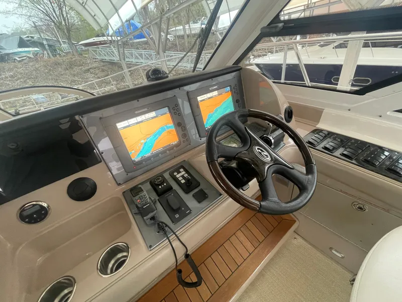 Slide: The Image of Helm of 2008 Sea Ray 550 Sundancer with dual navigation screens and steering wheel. - 28