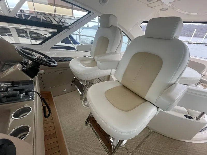 Slide: The Image of 2008 Sea Ray 550 Sundancer helm with luxurious white leather seats and modern controls. - 29