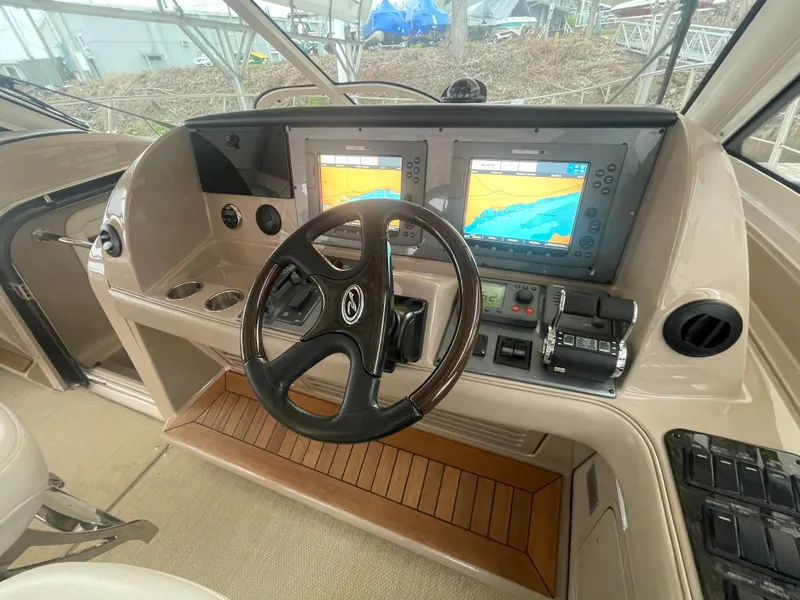 Slide: The Image of 2008 Sea Ray 550 Sundancer helm with dual navigation screens and steering wheel. - 31