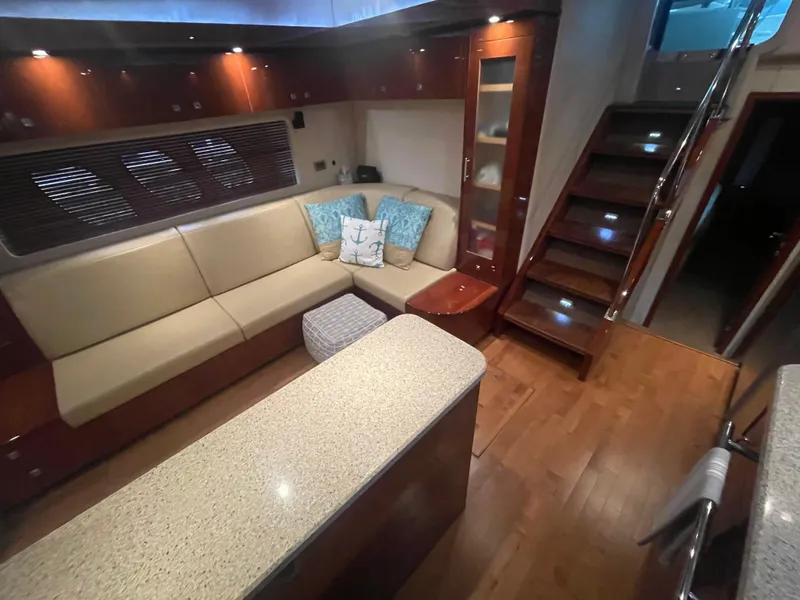 Slide: The Image of Luxurious interior of 2008 Sea Ray 550 Sundancer yacht with modern seating and wooden flooring. - 33