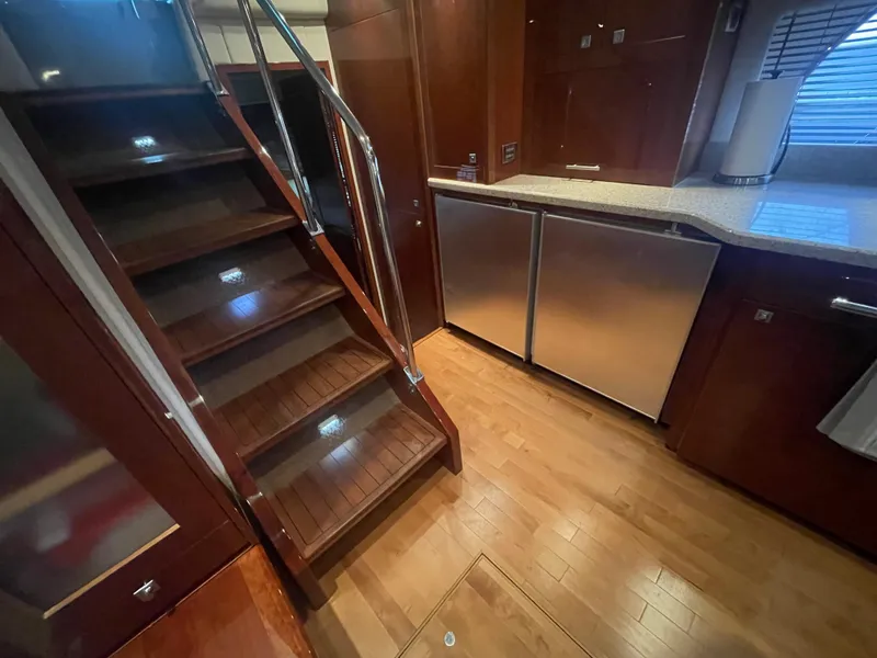Slide: The Image of Luxurious interior of 2008 Sea Ray 550 Sundancer yacht with wooden stairs and modern kitchen. - 36