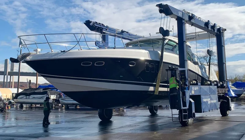 Slide: The Image of 2008 Sea Ray 550 Sundancer yacht being lifted by a large crane at a marina. - 4