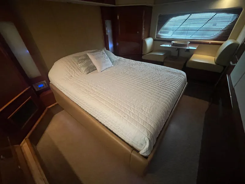 Slide: The Image of Luxurious bedroom interior of 2008 Sea Ray 550 Sundancer yacht with cozy bed and seating area. - 45