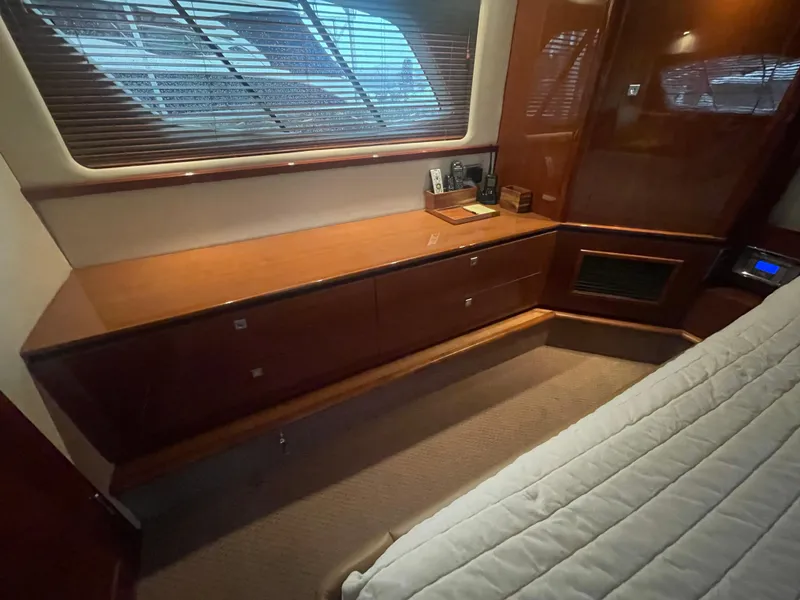Slide: The Image of Interior cabin of 2008 Sea Ray 550 Sundancer with wooden cabinetry and window blinds. - 46